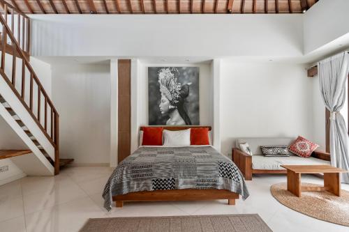 a bedroom with a bed and a stair case at Villa Alba, Berawa Beach in Canggu