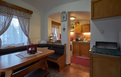 a kitchen and living room with a table and a dining room at Chalupa u rybára s Wellness a detským ihriskom in Liptovský Trnovec