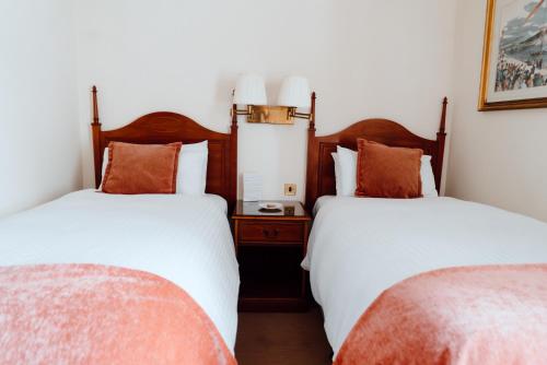 two beds sitting next to each other in a room at Royal Hotel in Stornoway