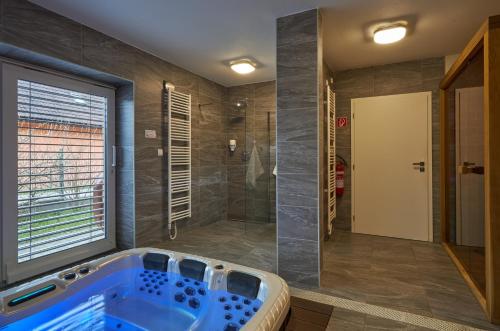 a large bathroom with a tub and a shower at Chalupa u rybára s Wellness a detským ihriskom in Liptovský Trnovec