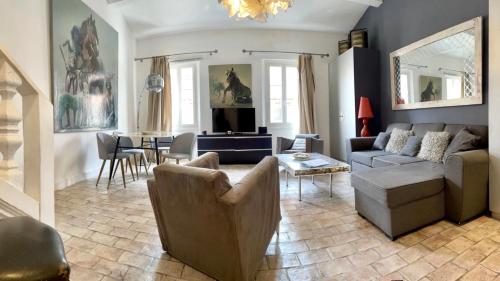 a living room with a couch and a table at Les Remparts Antibes Location in Antibes