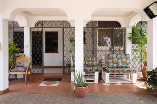 a porch of a house with two chairs at Bonsai Villa in Nairobi