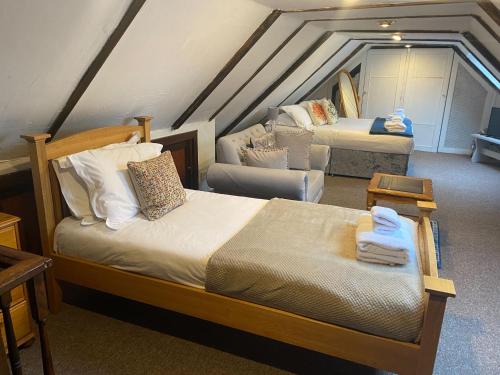 a bedroom with two beds in a attic at Dyke Farm Barn near Brighton by Huluki Sussex Stays in Brighton & Hove