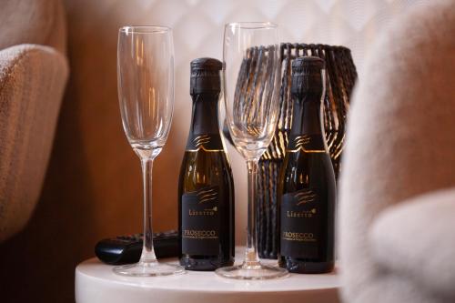 two bottles of wine and two glasses on a table at Kings Inn City Hotel Alkmaar in Alkmaar