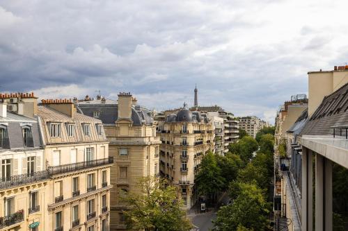 a view of a city with buildings and trees at Hôtel Etoile Maillot in Paris
