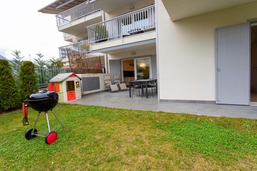 a barbecue grill in the yard of a house at Casa Aurora in San Michele allʼAdige