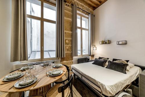 a room with a bed and a table with chairs at The incredible Suite Moulin - brand new 2022 in Lyon