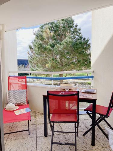 un balcon avec une table et deux chaises et une fenêtre dans l'établissement Nouveau * Ty Lévenez *pour 2 vacanciers * Parking, à Carnac