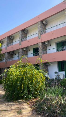 an apartment building with flowers in front of it at Auberge des Cascades Imouzzer - Paradise Valley in Imouzzer des Ida Ou Tanane