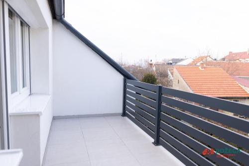 a balcony with a black and white railing at Apartment Eden in Požega