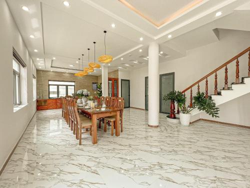 a dining room with a table and chairs at Villa Trung Nghĩa 36 in Ấp Ða Lợi