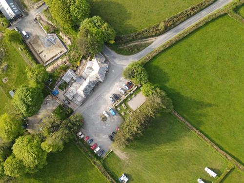 an aerial view of a parking lot with parked cars at Pitch 1 - Rising Sun Inn Campsite in Altarnun