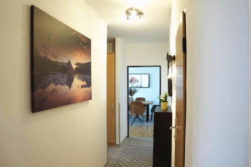 a hallway with a painting hanging on a wall at City Appartement Salzburg in Salzburg