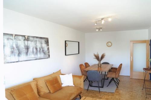 a living room with a couch and a table at City Appartement Salzburg in Salzburg