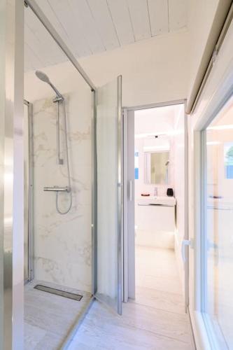 a bathroom with a shower with a glass door at Casa Quattordici in Cesena