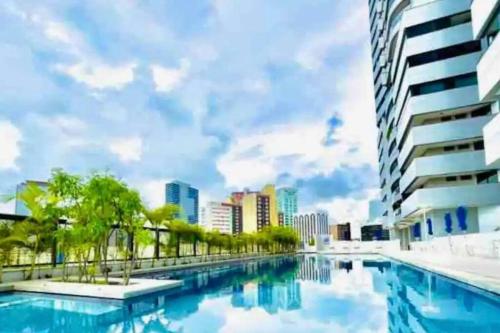 a swimming pool in a city with buildings at Salvador Prime Premium 2 suítes in Salvador