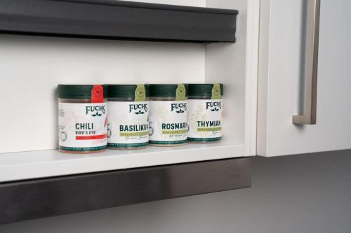 a row of spices in a kitchen cabinet at NEW modernes Loft im Zentrum von Deggendorf in Deggendorf