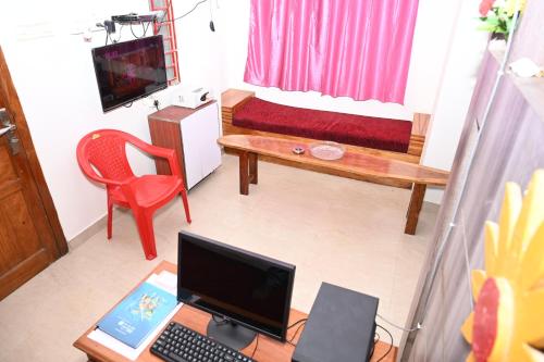a room with a desk with a laptop and a couch at ANDAMAN EXQUISITE in Port Blair