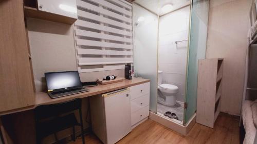a bathroom with a desk with a laptop computer on it at Haechi Stay GuestHouse - For foreigners only in Seoul