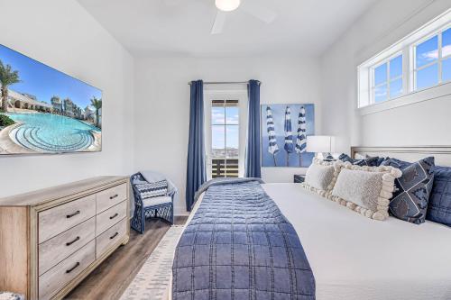 a bedroom with a large white bed and windows at Spanish Dagger Serenity in Port Aransas