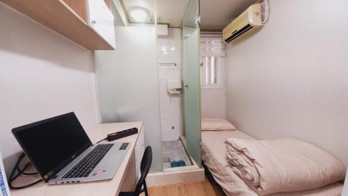 a laptop computer sitting on a desk in a room at Haechi Stay GuestHouse - For foreigners only in Seoul