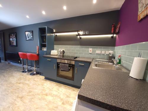 a kitchen with a sink and a counter top at Comfortable 1-Bed Apartment in Liverpool Sleeps 4 in Liverpool