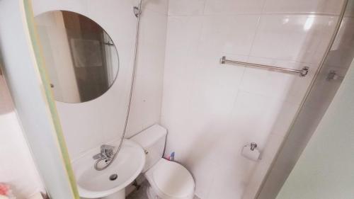 a small bathroom with a toilet and a mirror at Haechi Stay GuestHouse - For foreigners only in Seoul