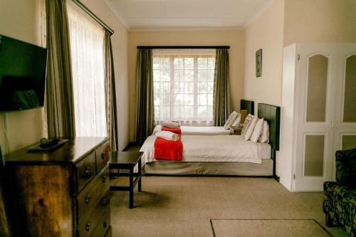 a bedroom with a large bed and a window at Thatchings Bed and Breakfast in Nottingham Road