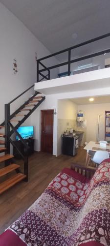a bedroom with a loft bed and a staircase at Casa - Departamento - Loft in Concepción del Uruguay