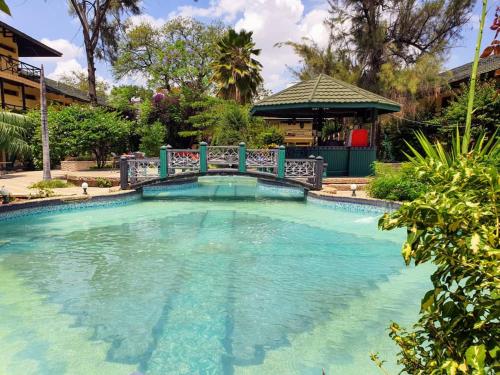 einen Pool mit einer Brücke im Hof in der Unterkunft Dodoma Rock Hotel Ltd in Dodoma