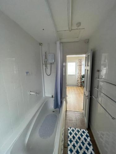 a bathroom with a bath tub in a room at Hillview 1st floor apartment in Brean