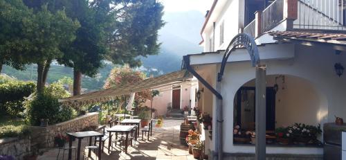 an outdoor patio with tables and chairs in a building at Agriturismo Mare e Monti in Tramonti
