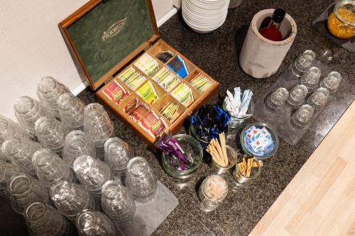 a group of glass dishes and glasses on a counter at Milling Hotel Mini 19 in Odense