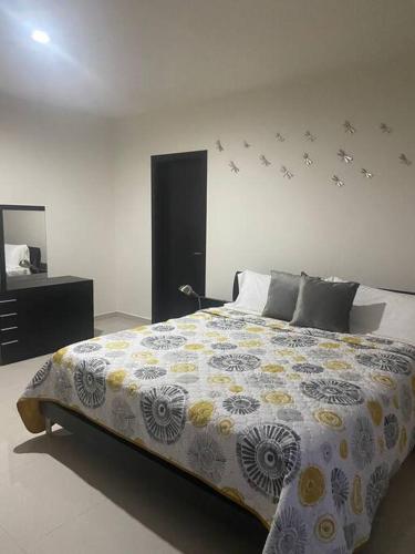 a bedroom with a large bed and a mirror at Residencia Campo Golf Altozano in Villahermosa