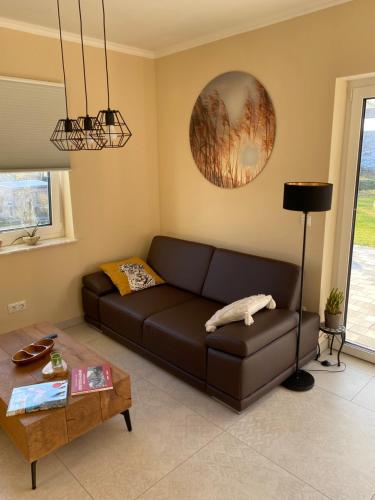a living room with a brown couch and a table at Ferienhaus Paula in Marlow