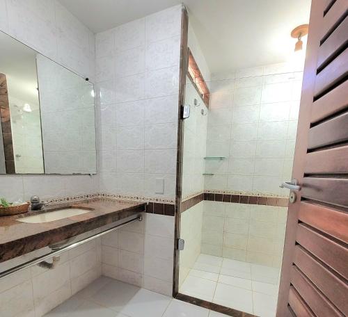 a bathroom with a shower and a sink at Pousada Riacho dos Milagres in São Miguel dos Milagres