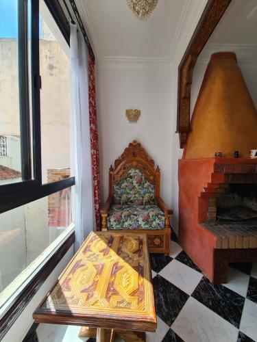 a small room with a bed and a fireplace at Maison d'hôte Bousaid in Chefchaouene