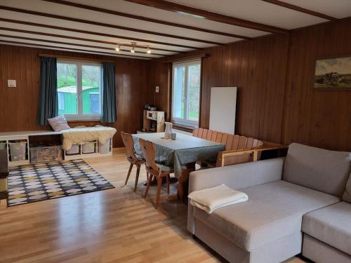 a living room with a couch and a table at Ferienhaus in der Natur in Schlossrued