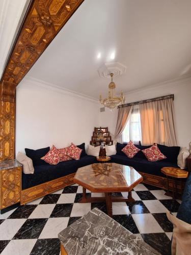 a living room with a couch and a table at Maison d'hôte Bousaid in Chefchaouene