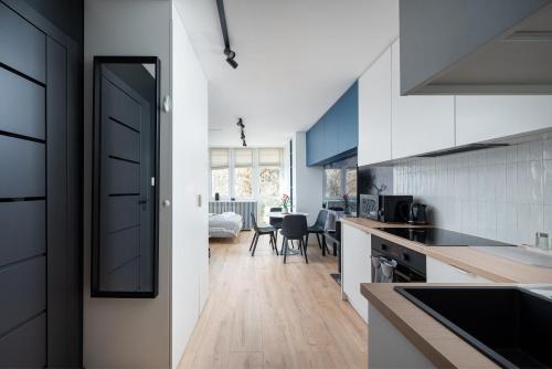 a kitchen with a door leading to a dining room at Mokotów Bełska Dream Studio in Warsaw