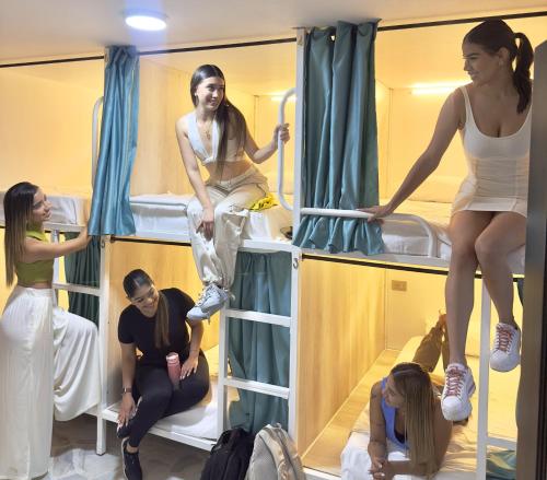 a group of people sitting in bunk beds at The View Hostel & Lounge in Cali