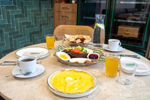 a table with a breakfast of food and orange juice at 21 Rooms Hotel in Istanbul