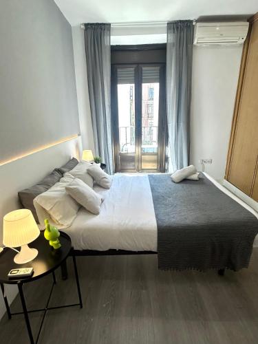 a bedroom with a large bed and a window at Centric 3ºI in Madrid