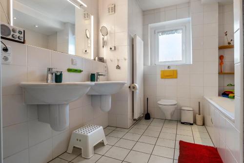 a white bathroom with a sink and a toilet at Ferienwohnung Glückauf in Castrop-Rauxel