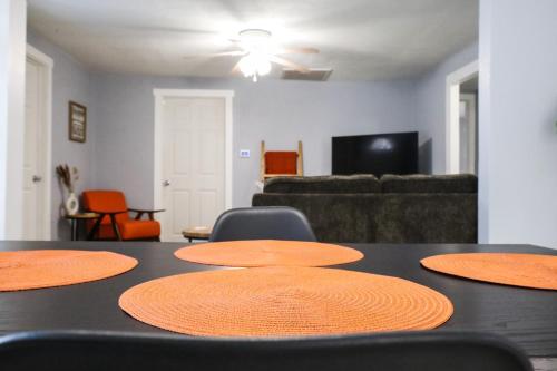 a black table with four chairs and a living room at The Main Nest - Near City Center in Klamath Falls