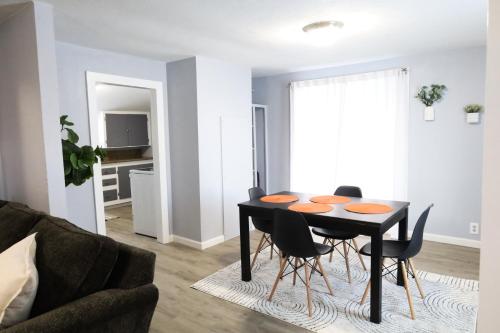 a dining room table and chairs in a living room at The Main Nest - Near City Center in Klamath Falls