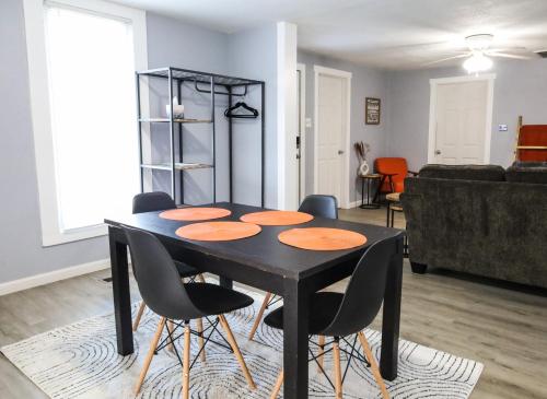 a black dining room table and chairs in a living room at The Main Nest - Near City Center in Klamath Falls