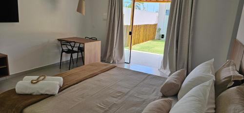 a bedroom with a large bed with a cross on it at Pousada Alkamar in Maragogi