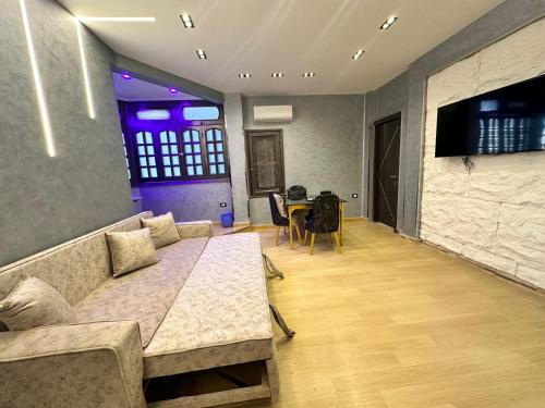 a living room with a couch and a table at MidtownTahrirViewSuites in Cairo