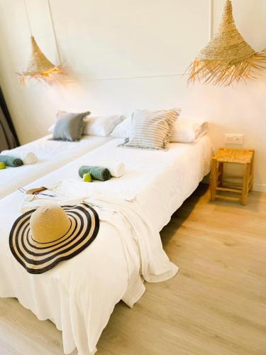 two beds with hats on them in a room at COLLECTION PORT - B&B Boutique , Alicante Center in Alicante